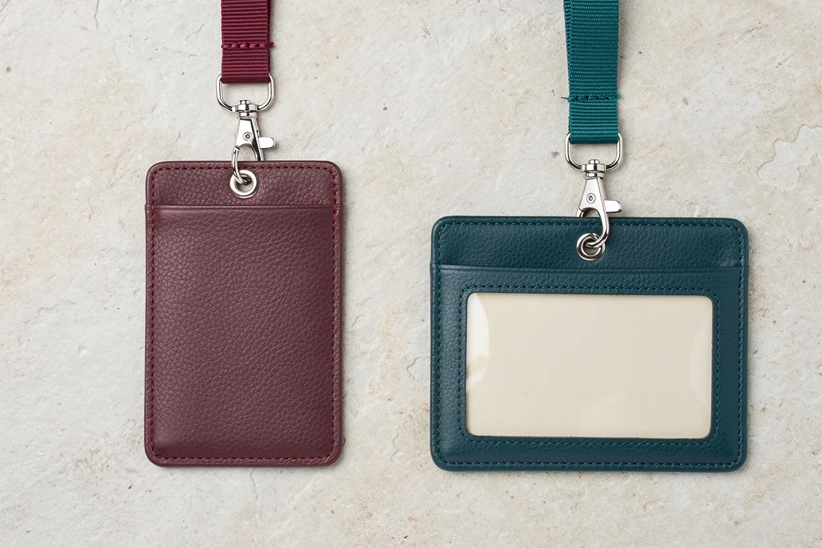 Burgundy portrait and teal landscape holders attached to lanyards with metal clips