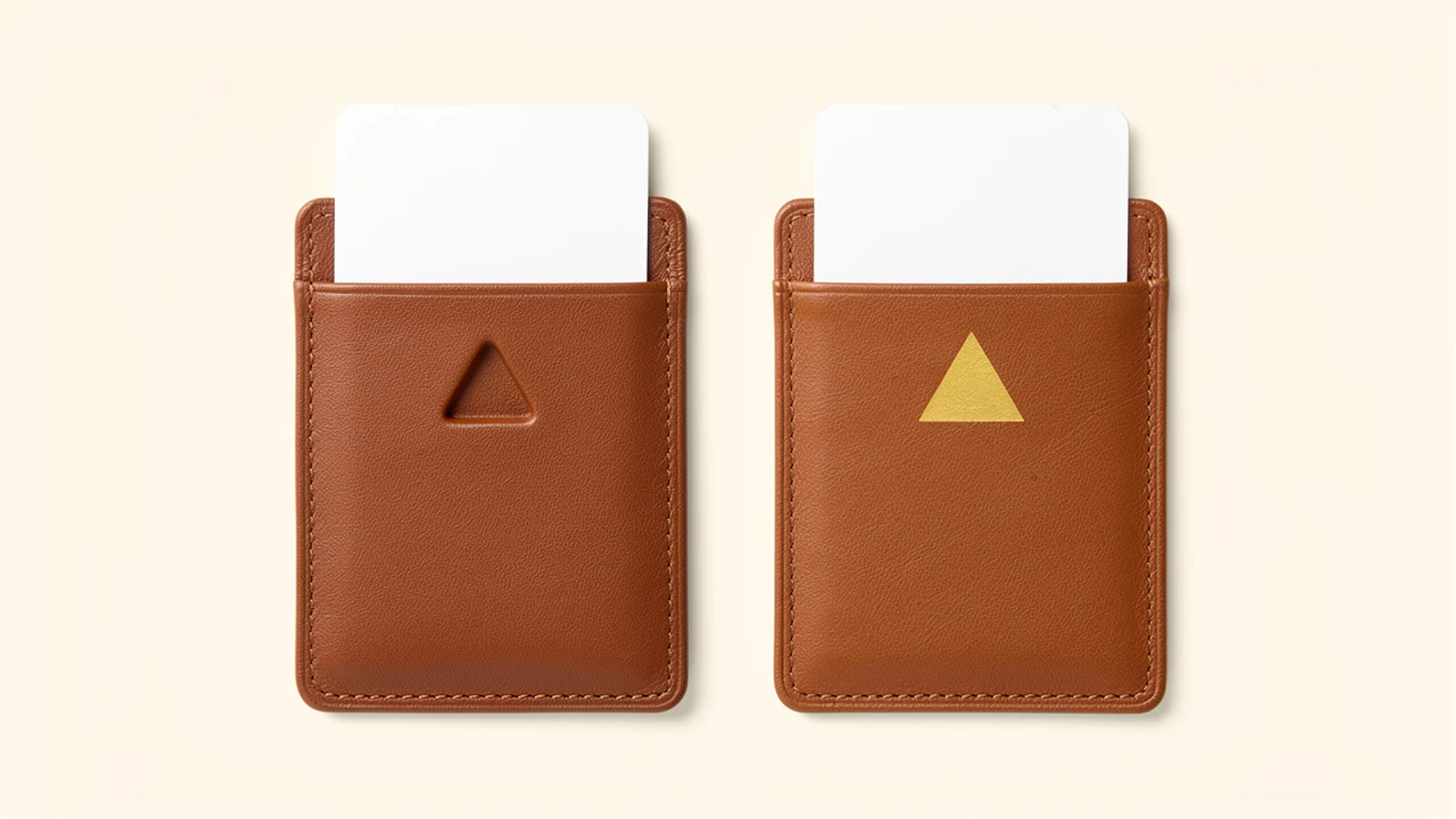 Two tan card sleeves with triangular marks, one tone-on-tone and one gold colored