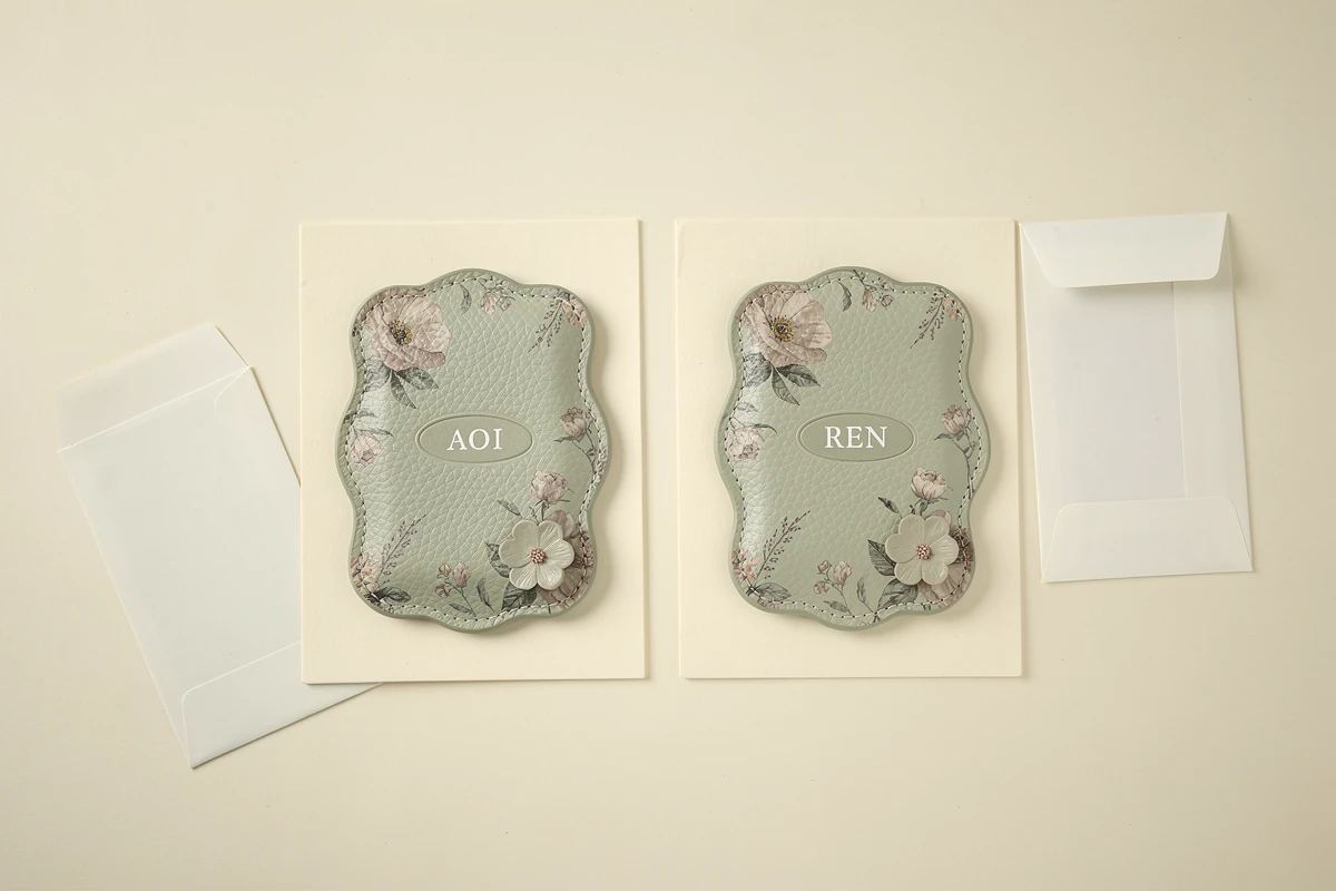 Sage floral pass case concepts with fictional names AOI and REN on backing cards beside paper sleeves